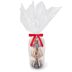 Three personal-size bundt cakes stacked vertically, packaged in a plastic container and gift-wrapped in cellophane. 