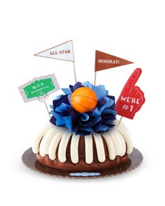 Large cake with foam finger reading "We're #1" and a basketball in the center. 
