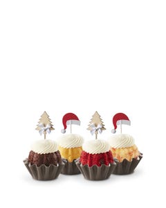 Each Bundtini® is adorned with a festive topper: two feature silver Christmas tree decorations and the other two have red Santa hats.
