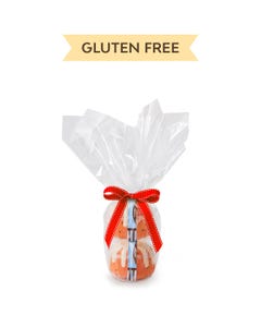 Two personal-size Gluten Free Chocolate Chip Cookie bundt cakes stacked vertically, packaged in a plastic container and gift-wrapped in cellophane. 