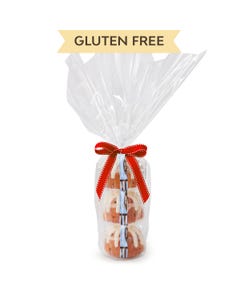 Three personal-size Gluten Free Chocolate Chip Cookie bundt cakes stacked vertically, packaged in a plastic container and gift-wrapped in cellophane. 