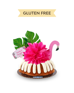 A Gluten-Free Chocolate Chip Cookie bundt cake decorated with a pink flamingo with tropical leaves. It also includes a card that reads Party in Paradise. 