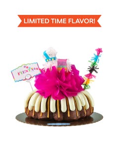 Limited time flavor! A party-themed bundt cake with a colorful mini piñata at the center and a piñata stick next to it. The cake has a card that reads FIESTA. 