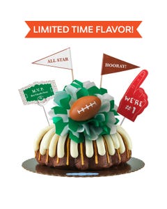 Limited Time Flavor! A REESE'S Chocolate Peanut Butter bundt cake, decorated with a mini football on top of a green and white bow in the center of the cake.