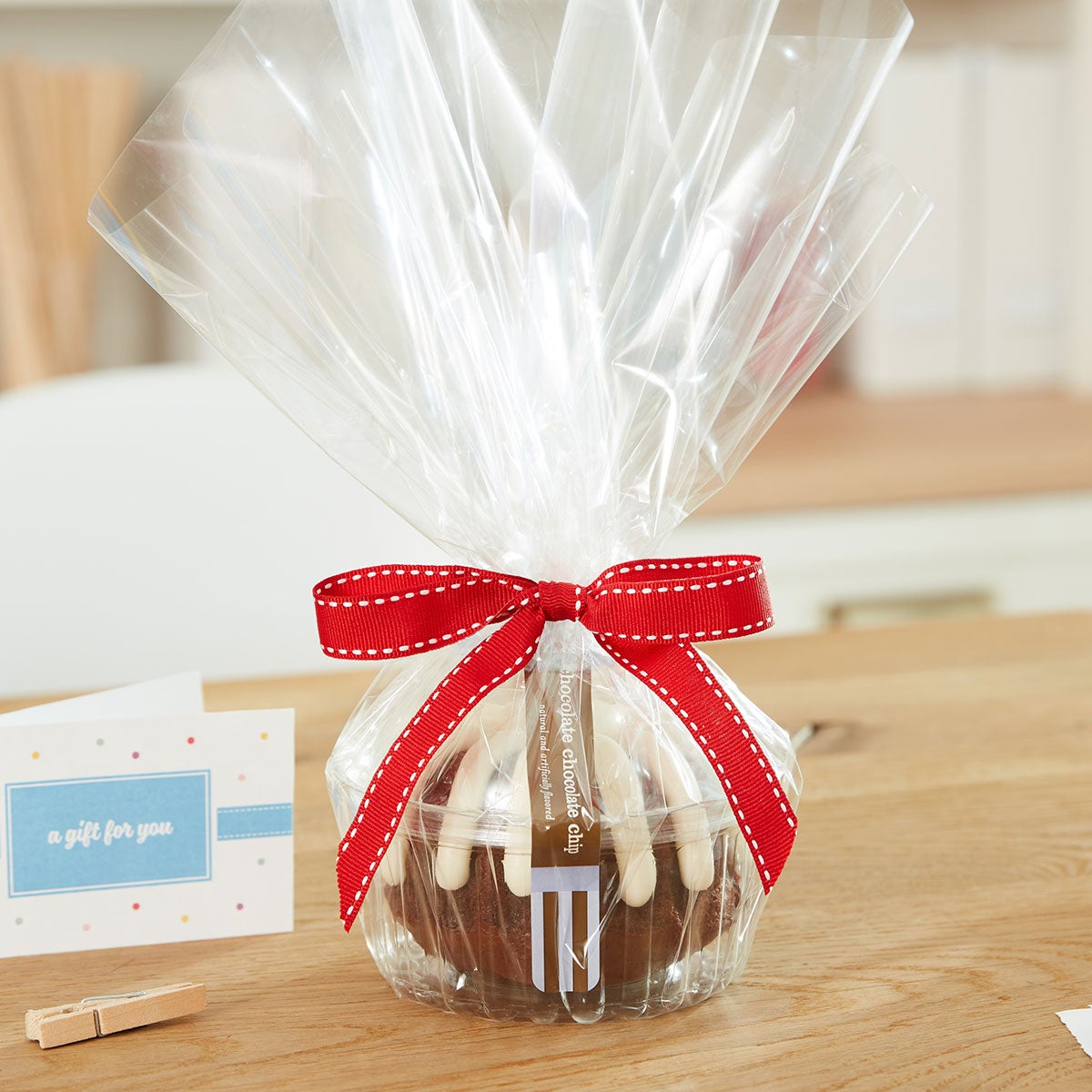 Personal size bundt cake, packaged in a plastic container and gift-wrapped in cellophane. 