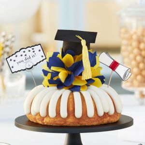 Congratulations cake with bow and graduation cap on top