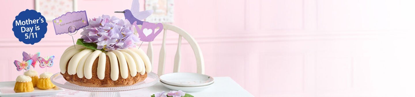 Table featuring Butterflies Bundtinis and Best Mom A'round Bundt cake. Mother's Day is 5/11.