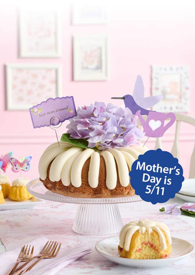 Table featuring Butterflies Bundtinis and Best Mom A'round Bundt cake. Mother's Day is 5/11.