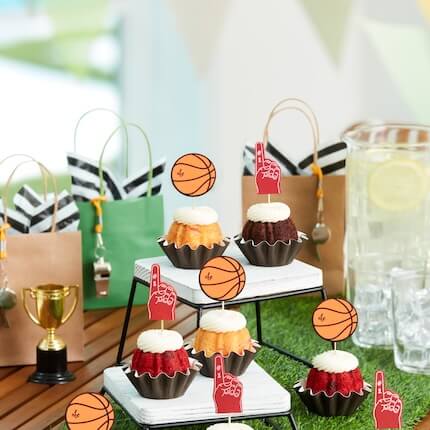 Assorted Bundtinis featuring Football toppers on a table for a part