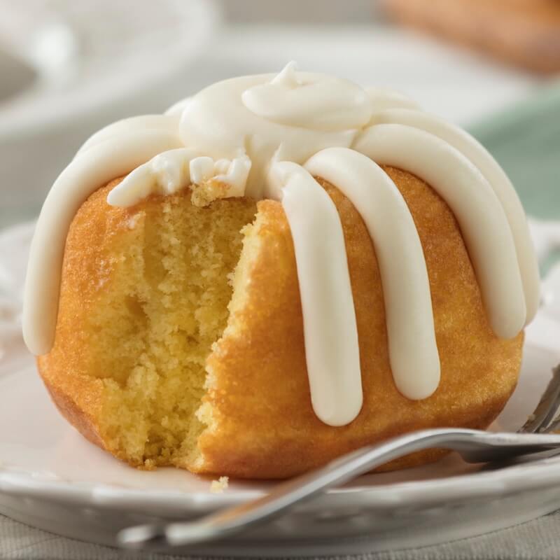 Individual Lemon Bundtlet showing the middle of the cake and signature frosting on top - Shop Bundtlets & Towers