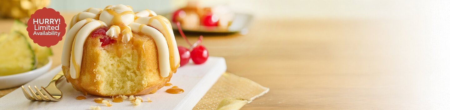 Featuring a pineapple upside down Bundtlet, showing part of the middle with a fork on the side. Limited Availability.