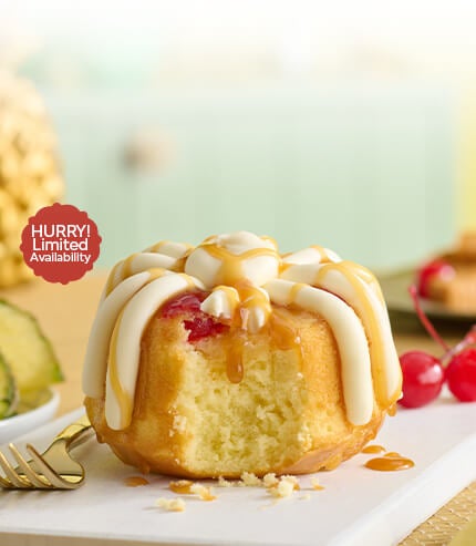 Featuring a pineapple upside down Bundtlet, showing part of the middle with a fork on the side. Limited Availability.