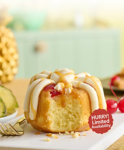 Featuring a pineapple upside down Bundtlet, showing part of the middle with a fork on the side. Limited Availability.